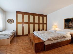 a bedroom with two beds and a large window at Belvilla by OYO Fiamme Grande in Predazzo