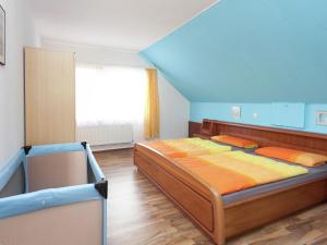 a bedroom with a large bed and a window at Apartment in health and Kneipp resort in the Upper Harz with huge garden in Wildemann