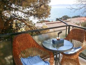 a table and two chairs on a balcony with the ocean at Cozy Apartment Brela in Brela +32 photos