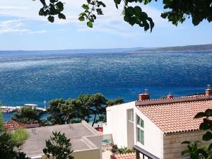 a view of the ocean from a house at Delightfully decorated apartment with a sea view 5 minutes to the beach in Brela