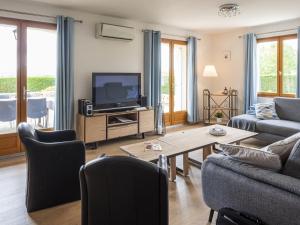 a living room with a couch and a tv at Luxury villa with pool in Malvi s in Malviès