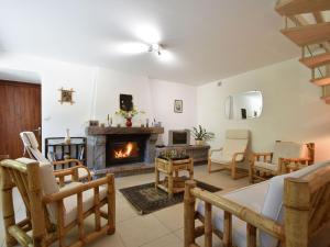 a living room with a fireplace and chairs at Superb holiday home with private garden in Yvias