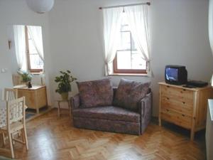 a living room with a couch and a tv in it at Apartmány Vrchlabí in Vrchlabí