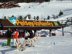 a group of people on a ski lift in the snow at Charming chalet with view on Mont Blanc in Peisey-Nancroix