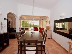 a dining room and living room with a table and chairs at Fantastic Villa in Albufeira with Private Swimming Pool in Albufeira