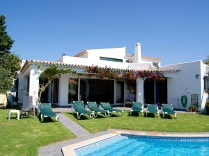 a villa with a swimming pool in front of a house at Fantastic Villa in Albufeira with Private Swimming Pool in Albufeira