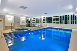 a large swimming pool in a large room at Novotel Melbourne On Collins in Melbourne