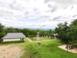 a park with a monument and a building at Diamond Village Pai in Pai