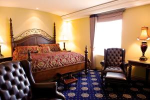 A bed or beds in a room at Chateau Louis Hotel & Conference Centre