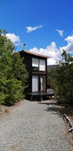 a small house sitting on top of a gravel road at The Loft in Las Trancas
