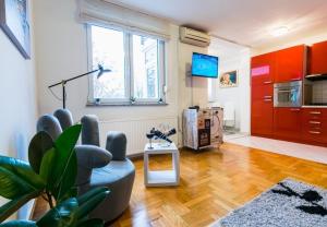 a living room with red cabinets and a television at Apartment Meri Jarun - near lake in Zagreb