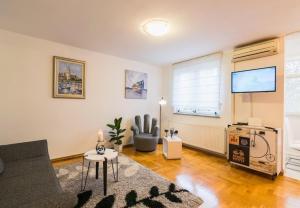a living room with a couch and a flat screen tv at Apartment Meri Jarun - near lake in Zagreb