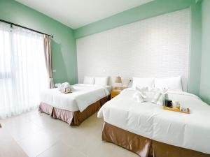 Postel nebo postele na pokoji v ubytování 禾旅宿Ho Hostel 墾丁夢幻島