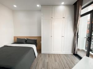 - une chambre avec un lit et une armoire blanche dans l'établissement B786 Tân Bình Homestay, à Hô-Chi-Minh-Ville