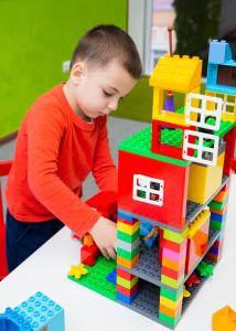 a young boy playing with a lego house at Liberty Fly Hotel in Adler