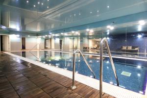 a swimming pool in a large building with a swimming pool at 107 - King David Residence - Jerusalem-Rent in Jerusalem