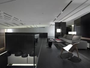 a living room with a couch and a table at The Met Hotel Thessaloniki, a Member of Design Hotels in Thessaloniki