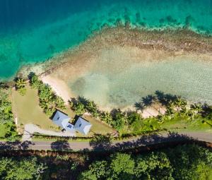an aerial view of a house on an island in the ocean at Le Neliza Beach Lodge Raiatea in Opoa