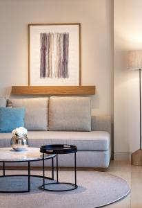 a living room with a couch and a table at Vathi Cove Luxury Resort & Spa in Chrysi Ammoudia