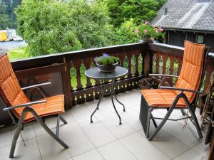 a patio with two chairs and a table on a balcony at Mila 4 in Champéry