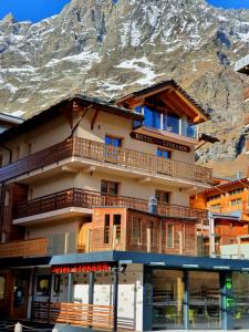 a building with a mountain in the background at Hotel Lyskamm in Breuil-Cervinia