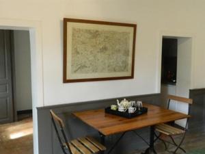 a dining room with a wooden table and chairs at La Foutelaie in Clefs-Val d'Anjou