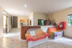 a room with two beds and a counter in it at OYO Residencial Muriqui Apart Hotel, Mangaratiba in Vila Muriqui