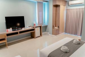 uma sala de estar com uma televisão de ecrã plano sobre uma mesa em It's me Keawanong Hotel em Nakhon Ratchasima