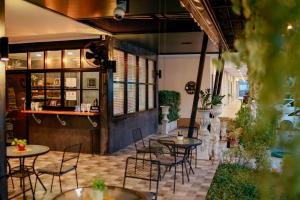 a patio with tables and chairs in a restaurant at It's me Keawanong Hotel in Nakhon Ratchasima