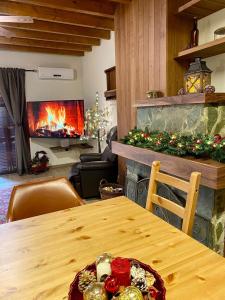 a living room with a table and a fireplace at Cozy mountain apartment in Platres in Platres