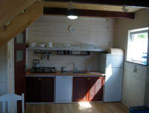 a kitchen with a white refrigerator and a sink at Grzywaczówka in Przesieka