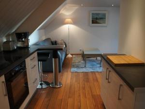 a kitchen with a counter top and a living room at Intra Muros Vue Mer in Saint Malo