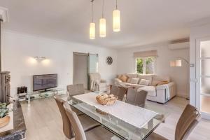 a living room with a glass table and chairs at Casa Mediterranea in Santa Margalida