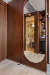 a bathroom with a large mirror on a wooden wall at Hotel 1936 in Hong Kong