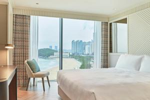 a hotel room with a view of the ocean at Grand Josun Busan in Busan