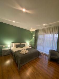 a bedroom with a bed with two towels on it at Royal Rest in Belokrinichʼye