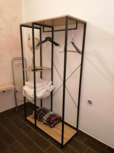 a room with a stand with shelves and towels at Le antiche mura 2 in Sassari