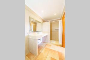 ein weißes Badezimmer mit Waschbecken und Spiegel in der Unterkunft Villa Luis Vives By SunVillas Mallorca in Port de Pollença