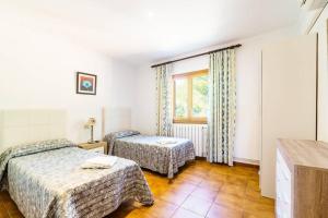 Ein Bett oder Betten in einem Zimmer der Unterkunft Villa Luis Vives By SunVillas Mallorca