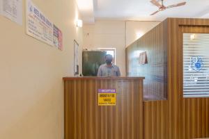 a man standing behind a podium in a room at KSTDC Hotel Mayura Gerusoppa, Jogfalls in Māvingundi