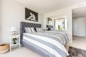 Un dormitorio blanco con una cama grande y una ventana en The Edge Front Line Beach Luxury and Spa en Estepona
