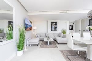 a living room with a couch and a table at The Edge Front Line Beach Luxury and Spa in Estepona +22 photos