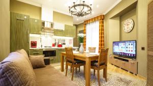 a living room with a dining room table and a television at OldRigaLuxApart free parking in Riga