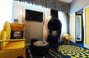 a living room with a couch and a chair at Malmaison Hotel Leeds in Leeds