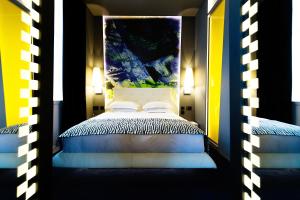 a bedroom with a canopy bed with blue and yellow at Malmaison Hotel Leeds in Leeds