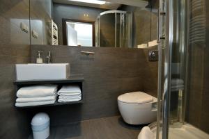 a bathroom with a sink and a toilet and a mirror at Apartamenty TOP Garbary in Poznań
