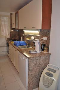 a kitchen with a sink and a washing machine at L'Appart in Bonifacio