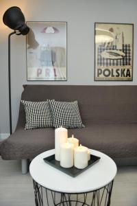 a living room with a coffee table with candles on it at Apartamenty TOP Garbary in Poznań