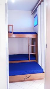 a bunk bed in a room with a blue mattress at Eldorado Flat Service in Caldas Novas +44 photos