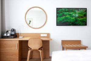 a dressing table with a mirror and a chair at Botanique Hotel Prague in Prague